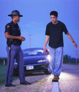 Man doing field sobriety test with police officer